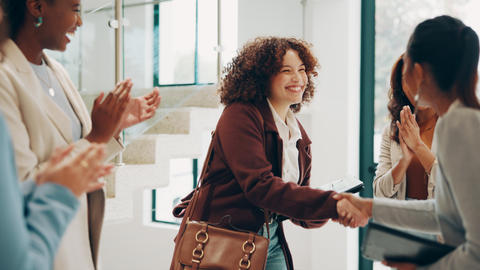 A student shakes someone's hand at a job interview