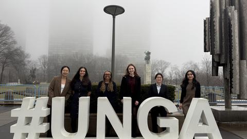 Six students pose in front of the United Nations installation during the United Nations Commission on the Status of Women 70.