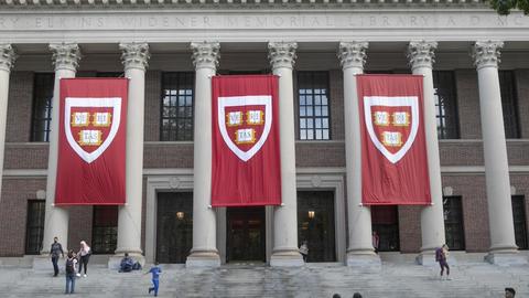 Widener Library with three crimson Harvard banners
