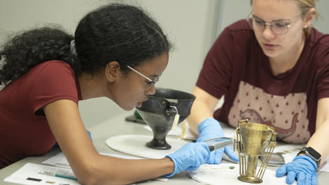 Students exam Greco-Roman objects at the Harvard Art Museum.
