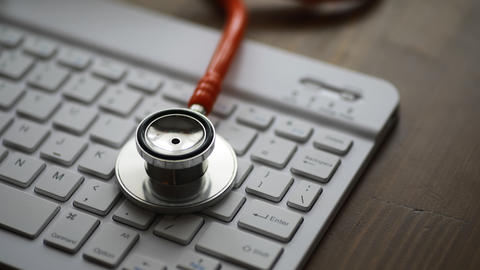A stethoscope lies on a keyboard 