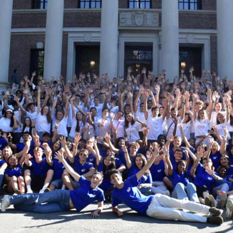 Students pose for a group photo during the first-year international program on Widener Library steps.