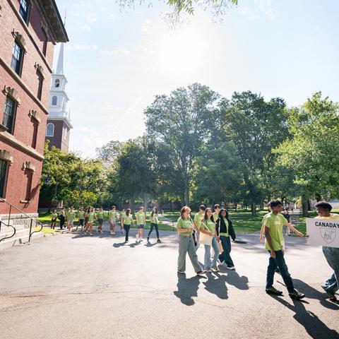 First-year students going through the Yard with their dorm community on their way to an orientation event.
