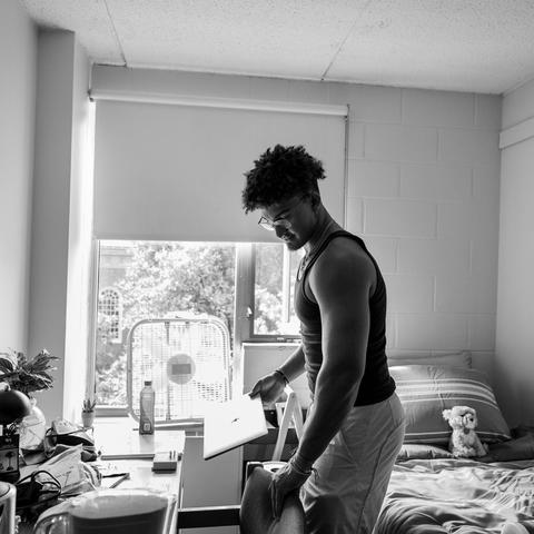 A student unpacking their room upon move-in.