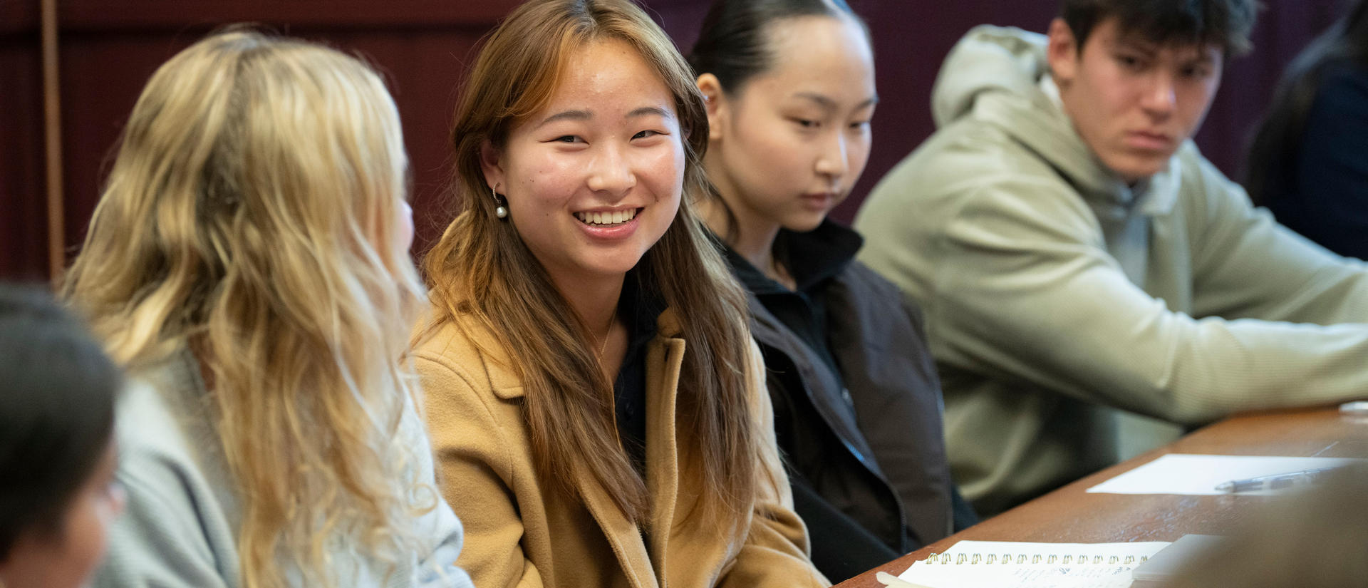 A student smiles in class.